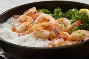 Enjoy this speedy meal that combines brown rice with shrimp in a tasty ginger-soy-sesame sauce. Adding tomatoes and avocado not only brings color but also nutrients to the dish. 